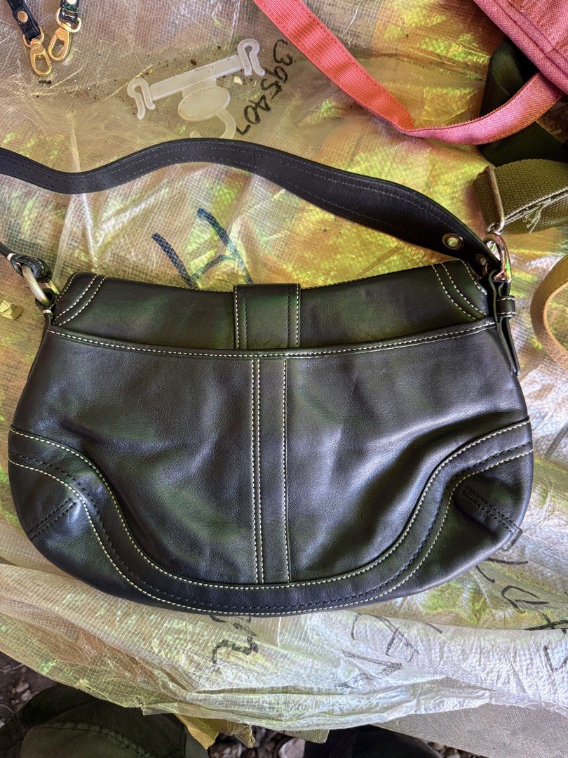 Coach Soho Black Leather Shoulder Bag (Category: Luxury Bags & Wallets) located in Brookes Point. Submitted by jaythrift_lowkey (Listing ID 1460310725, Image 2). Description: - Authentic Coach black leather shoulder bag - Elegant white stitching detail - Secure silver buckle closure - Adjustable strap for comfortable wear - Ample interior space for essentials - Ideal for everyday use.