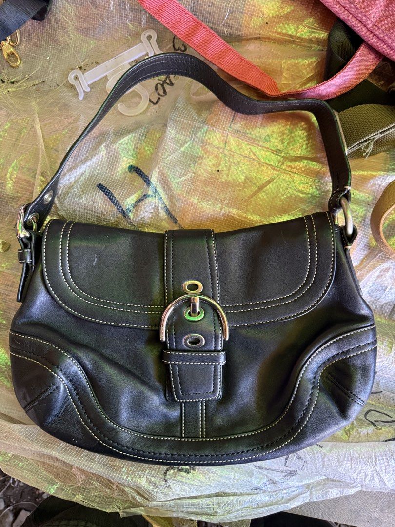 Coach Soho Black Leather Shoulder Bag (Category: Luxury Bags & Wallets) located in Brookes Point. Submitted by jaythrift_lowkey (Listing ID 1460310725, Image 1). Description: - Authentic Coach black leather shoulder bag - Elegant white stitching detail - Secure silver buckle closure - Adjustable strap for comfortable wear - Ample interior space for essentials - Ideal for everyday use.