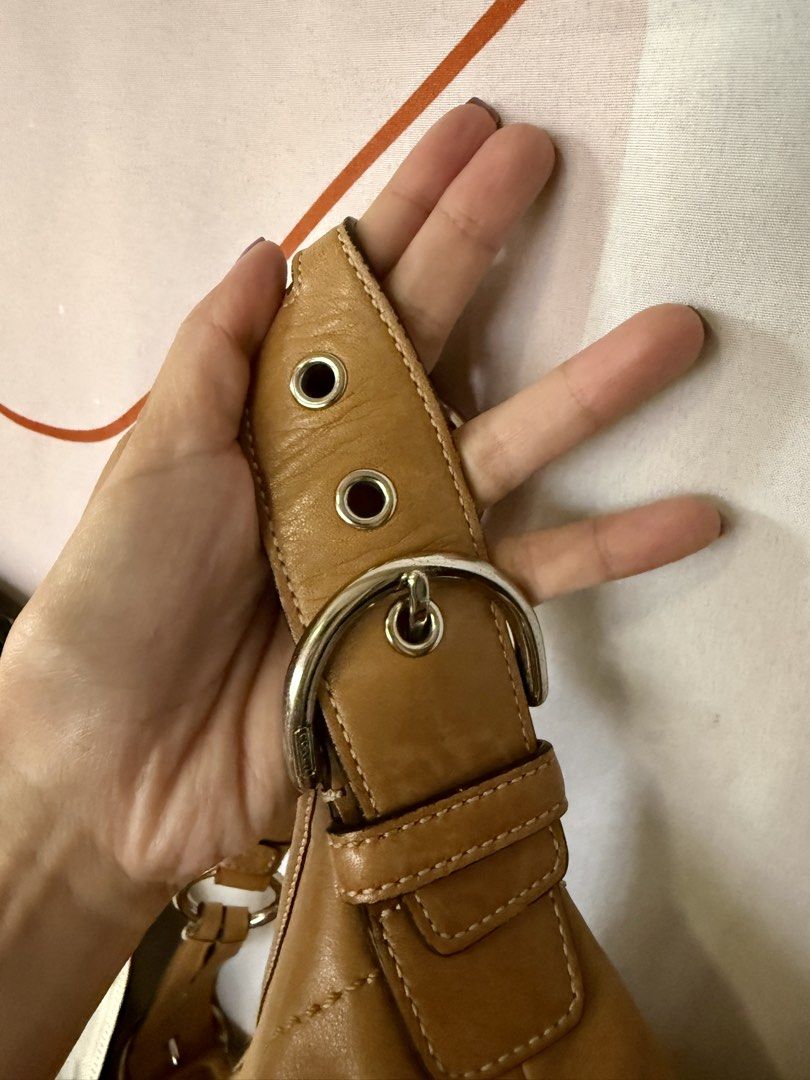 Coach Soho Hobo Shoulder Bag (Tan) (Category: Luxury Bags & Wallets) located in Quezon City. Submitted by elysejuan (Listing ID 1460366635, Image 2). Description: - ✨ RARE ✨ Authentic Coach tan leather hobo bag - Made from soft, glove-tanned cowhide - Features silver hardware details - Adjustable shoulder strap with buckle - Interior lined with Coach logo - Serial number: NK04S-3651.