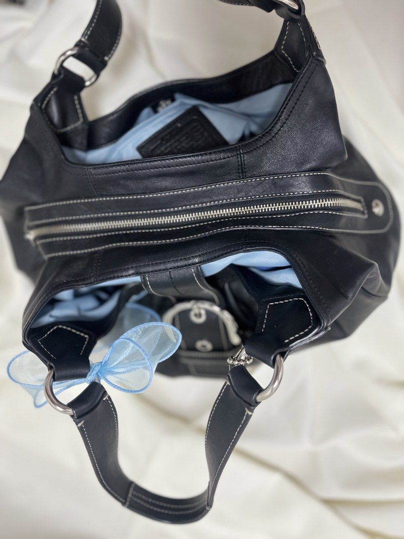 Coach Soho Lynn (Category: Luxury Bags & Wallets) located in Quezon. Submitted by consulhann69386 (Listing ID 1460356300, Image 3). Description: - Genuine black leather Coach hobo bag - Stylish silver buckle accent on the front - Secure zipper closure on top - Spacious interior with light blue lining - Blue interior .