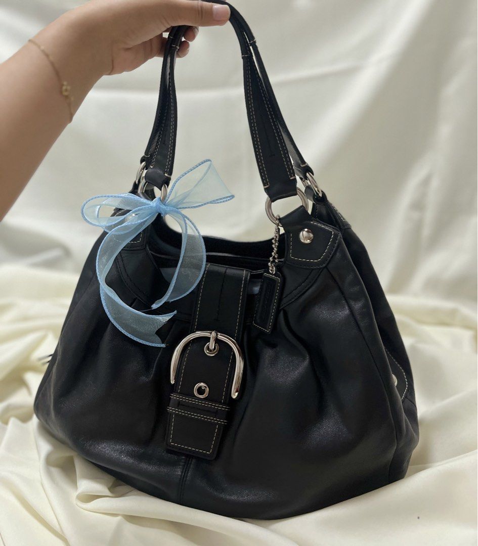 Coach Soho Lynn (Category: Luxury Bags & Wallets) located in Quezon. Submitted by consulhann69386 (Listing ID 1460356300, Image 1). Description: - Genuine black leather Coach hobo bag - Stylish silver buckle accent on the front - Secure zipper closure on top - Spacious interior with light blue lining - Blue interior .
