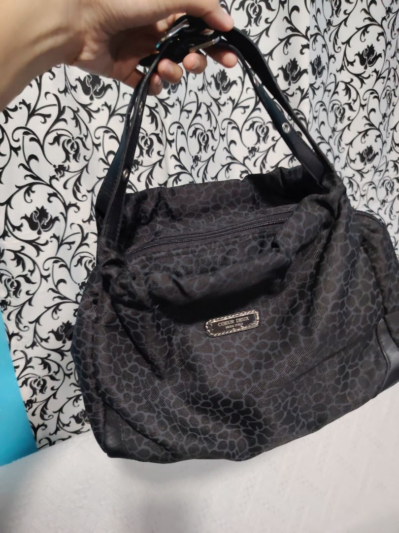 Coeur Deaux Black Leopard Print Shoulder Bag (Category: Shoulder Bags) located in Manila. Submitted by theshopandsmile (Listing ID 1460445340, Image 1). Description: - Brand: Coeur Deaux - Color: Black with subtle leopard print - Closure: Top zipper - Material: Leather trim and handles - Interior: Multiple compartments - Style: Shoulder bag - Features: Spacious, great for everyday use.