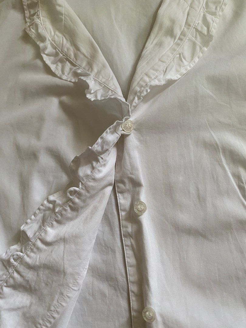 COMME ÇA ISM White Ruffled Blouse (Category: Blouses) located in Davao. Submitted by dollhouse_co (Listing ID 1460383227, Image 3). Description: - White Ruffled Blouse - Great condition / like new - Size: Small to Medium - Length: 57.4cm - Sleeves: 38.5cm MOD: Meet-up / Maxim / J&T MOP: GCash / RCBC .
