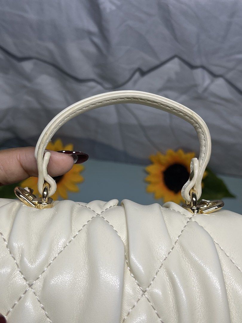 Cream Quilted Mini Handbag with Gold Chain Strap (Category: Luxury Bags & Wallets) located in Liloan. Submitted by sakurumifinds2809 (Listing ID 1460360910, Image 3). Description: - Adorable cream mini handbag - Chic quilted design - Elegant flower clasp closure - Convenient top handle - Detachable gold chain strap for versatility - Compact size, ideal for carrying essentials - Stylish gold hardware accents - Perfect accessory for evenings out or