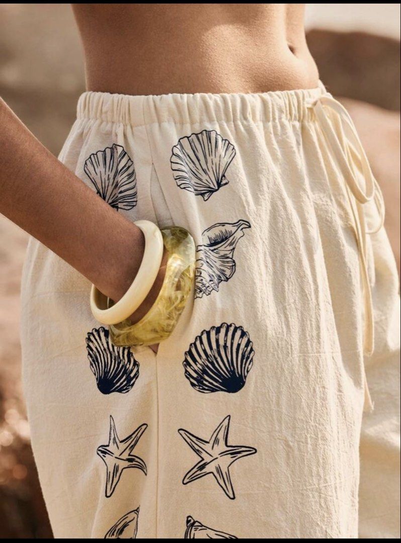 Cream Wide Leg Pants with Shell Print (Category: Other Bottoms) located in Cebu City. Submitted by mariz_cebu (Listing ID 1460308023, Image 2). Description: Pants only perfect for Beach outfit - Cream colored wide leg pants - Fun navy blue shell and lobster print on sides and hem - Comfortable drawstring waist - Perfect for beach days or casual outings - Versatile styling with bikini tops or light shirts.