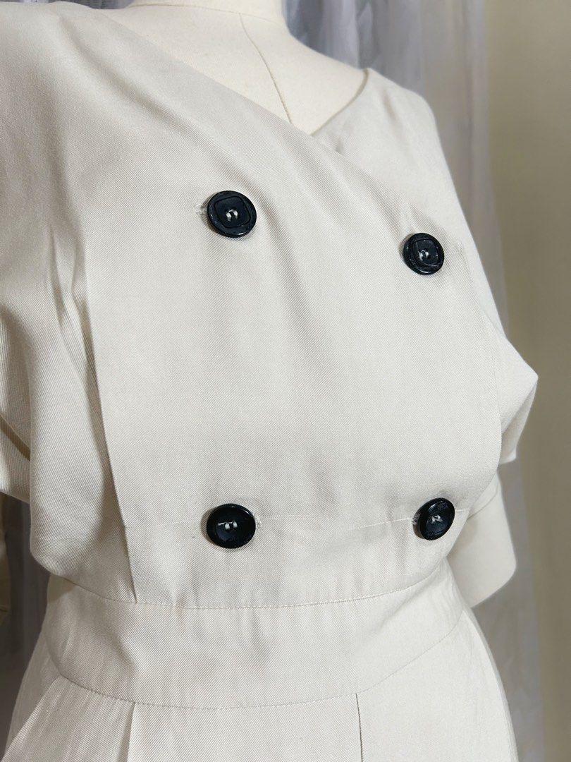 Cream Wide-Leg Jumpsuit (Category: Jumpsuits) located in Manila. Submitted by maison_marie (Listing ID 1460456964, Image 3). Description: Elegant cream-colored wide-leg jumpsuit featuring a sophisticated V-neckline. Size: Medium on tag ¾-length sleeves Flowing wide-leg pants Side zipper closure Twi functional side pockets. Minor imperfections: 2. Buttonhole stitching shows minor fraying/wear, but it is not very noticeable when worn and buttoned u