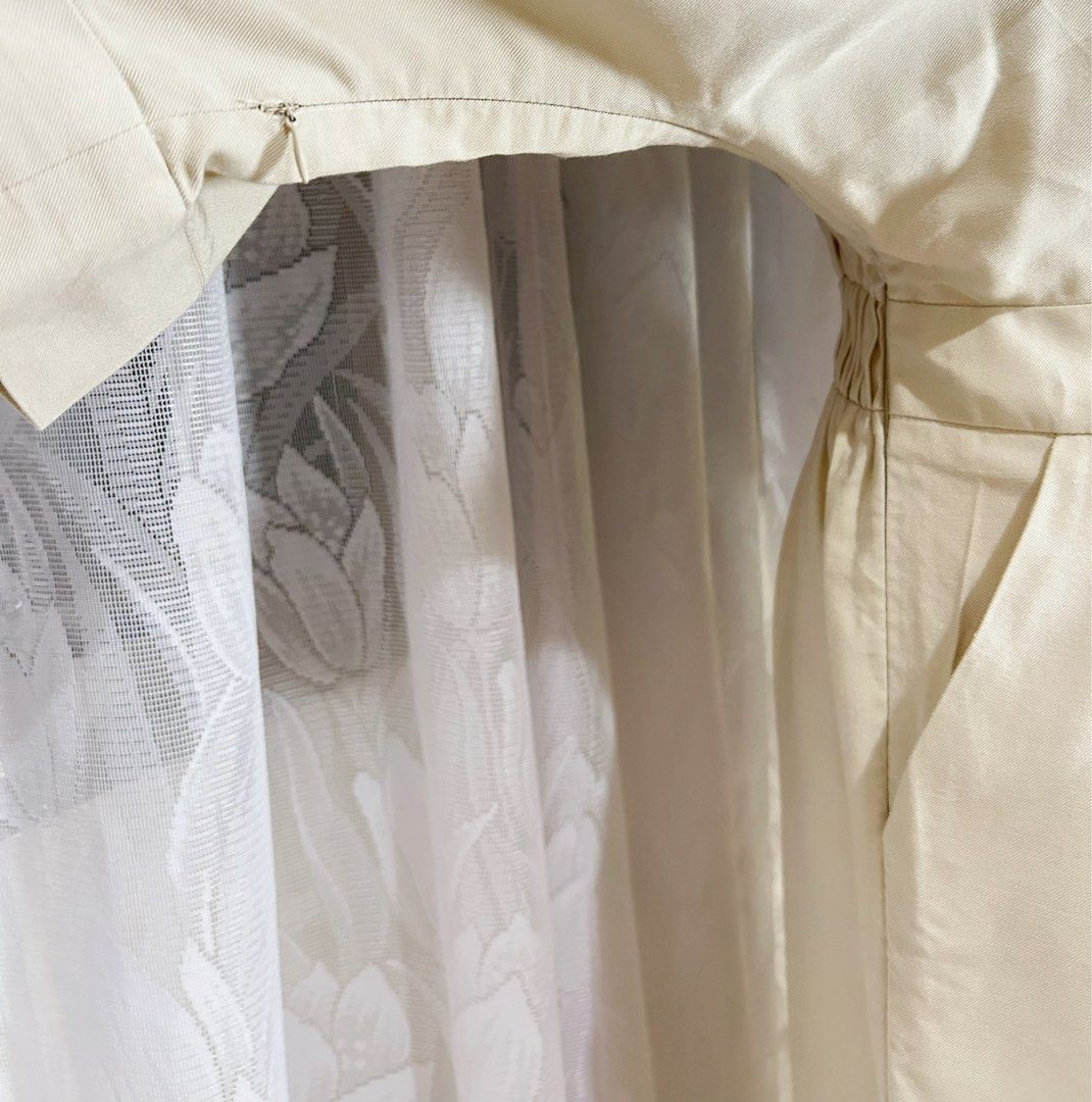 Cream Wide-Leg Jumpsuit (Category: Jumpsuits) located in Manila. Submitted by maison_marie (Listing ID 1460456964, Image 2). Description: Elegant cream-colored wide-leg jumpsuit featuring a sophisticated V-neckline. Size: Medium on tag ¾-length sleeves Flowing wide-leg pants Side zipper closure Twi functional side pockets. Minor imperfections: 2. Buttonhole stitching shows minor fraying/wear, but it is not very noticeable when worn and buttoned u