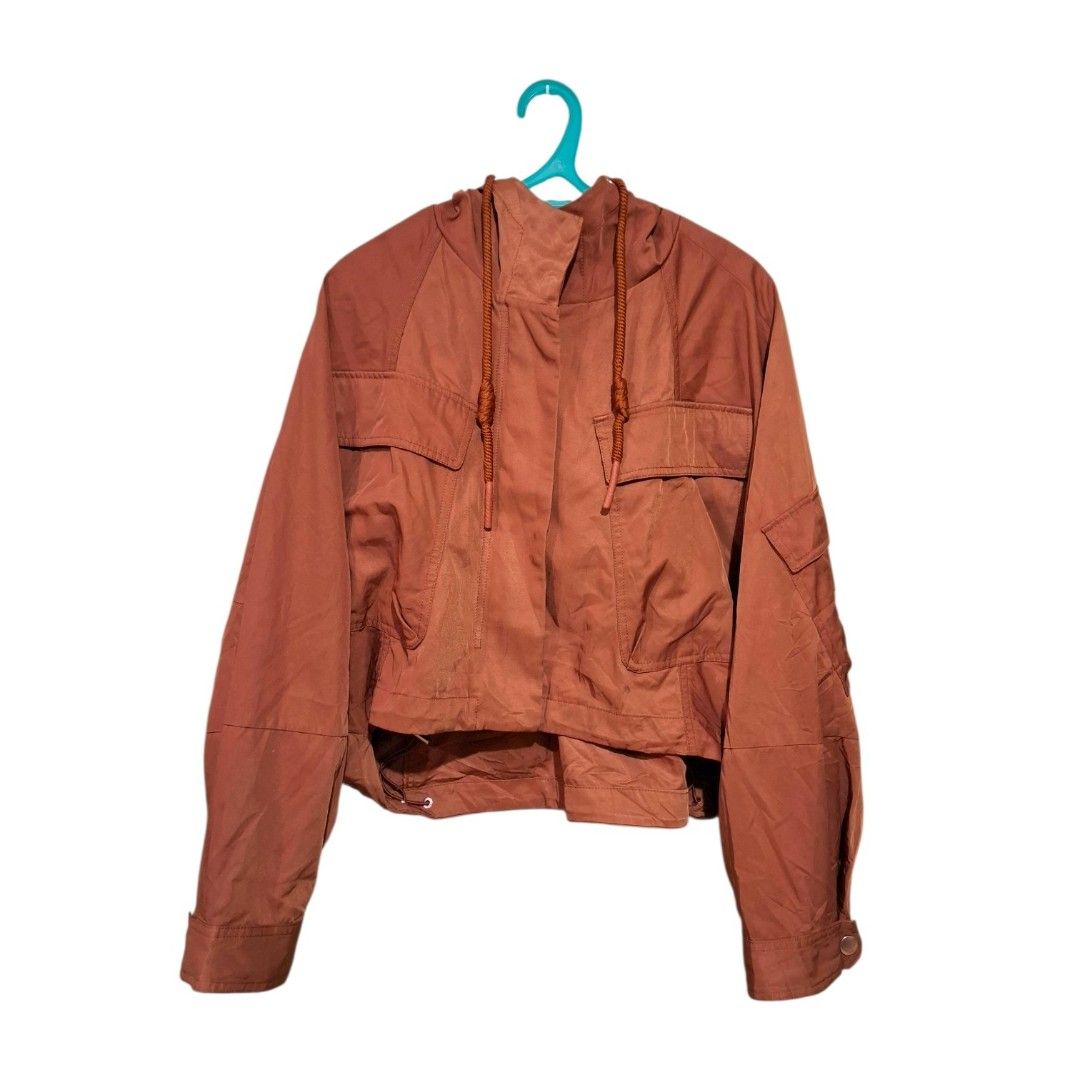 Cropped Hooded Utility Jacket with Pockets (Category: Coats, Jackets and Outerwear) located in Pasig City. Submitted by m_r_g (Listing ID 1460440180, Image 1). Description: - Rust orange hooded jacket - Cropped style - Drawstring hem and hood - Two chest pockets - Button cuffs - Lightweight material - Ideal for casual wear and layering.