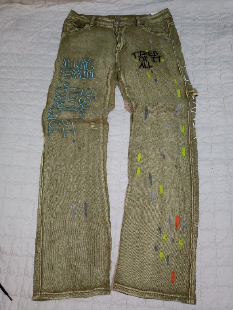 Custom Painted Cargo Jeans with Text (Category: Jeans) located in Allen. Submitted by milyonaryung_gipit (Listing ID 1460408066, Image 2). Description: - Unique cargo jeans - Custom paint splatters - Embroidered text: 'HELP ME' on one leg, 'ALWAYS TERRIBLE TOMORROW IS MUCH WORSE' on the other - 'XINYINXU' embroidery on the side - Distressed look - Relaxed fit - Statement piece.