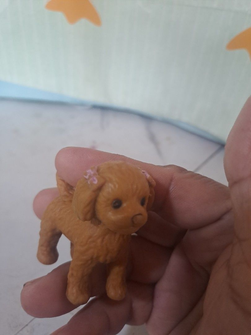 Cute Brown Dog Figurine Toy (Category: Figurines & Statues) located in Davao. Submitted by bravemoon_556cd5 (Listing ID 1460421563, Image 2). Description: - Adorable small brown dog toy - Resembles a poodle or similar breed - Features cute pink flowers on its ears - Ideal for collectors or as a plaything - Compact size, easy to carry - Great for children.