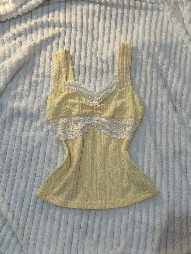Cute yellow coquette lace top (Category: Sleeveless) located in San Pedro. Submitted by bubbles_cutie (Listing ID 1460337506, Image 1). Description: Super love nung tela its really stretchy and when u try it hugs your body, also only tried it but i never worn it after trying kasi not my style anymore so sayang. Also small to medium siya.