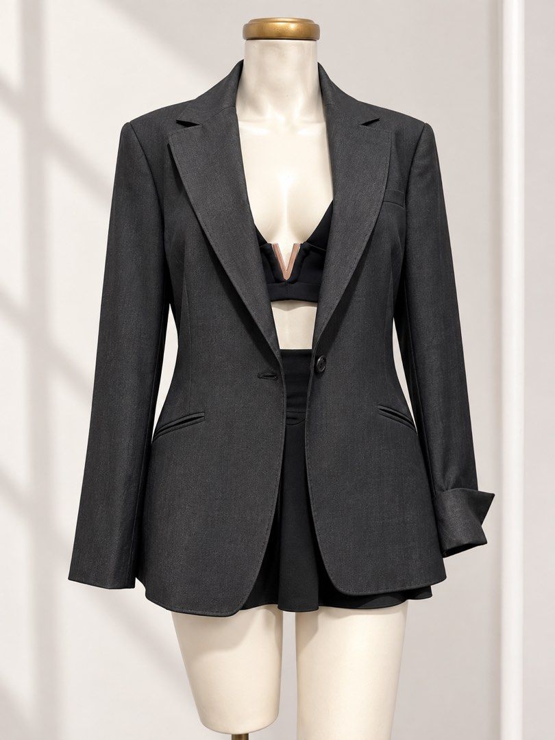 Dark Gray Blazer (Category: Coats, Jackets and Outerwear) located in Taguig. Submitted by vm.co (Listing ID 1460459024, Image 1). Description: Perfect for: * Corporate office wear * Business travel * Smart casual outfits * Rainy or cool weather * Capsule wardrobe * Everyday sophisticated styling Condition: Appears to be in very good preloved condition with no visible major stains, tears, or discoloration in the photo. A light steam will give it a