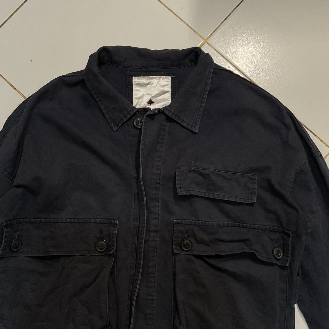 Dark Navy Utility Jacket with Four Pockets (Category: Coats, Jackets and Outerwear) located in Morong. Submitted by rusty.vault (Listing ID 1460457166, Image 2). Description: - Dark navy utility jacket - Collared neckline - Button-up front - Two chest pockets - Two lower front pockets - Long sleeves with button cuffs - Center seam detail on back - Simple, functional design.