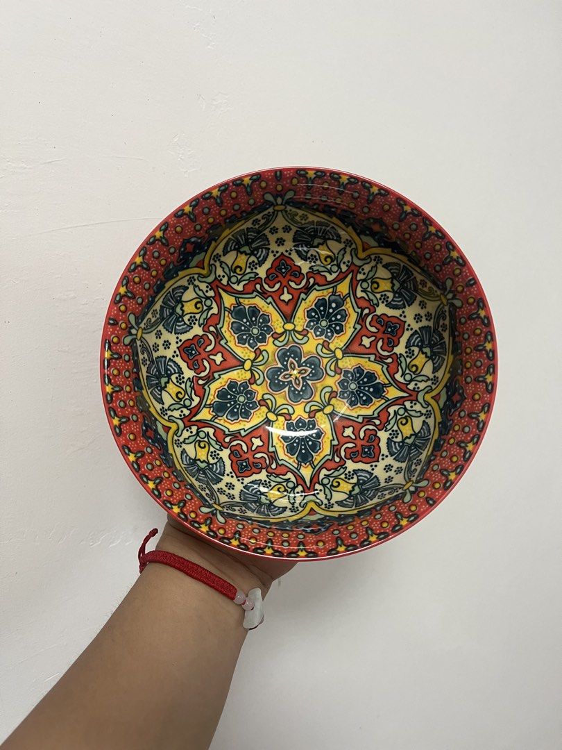 Decorative Ceramic Bowl with Intricate Pattern (Category: Vases & Decorative Bowls) located in Dasmarinas. Submitted by purpleboxmidori (Listing ID 1460471930, Image 1). Description: - Beautiful ceramic bowl with a vibrant, detailed pattern. - Solid red exterior. - Approximately 20cm in diameter. - Ideal for serving food or as a decorative accent. - Adds a pop of color to your table. - Dishwasher safe for easy cleaning..