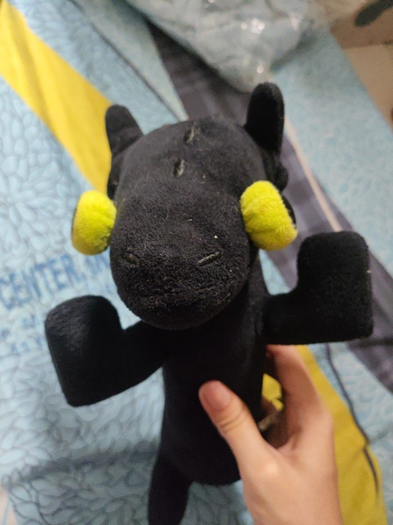 Derpy Toothless Dragon Plushie (Category: Plushies & Soft Toys) located in Manila. Submitted by prelovedby_joie (Listing ID 1460367550, Image 2). Description: - Cute toothless plush toy - Bright yellow eyes - Long body with four legs - Approximately 10 inches long - Shows some wear and tear on the feet - Perfect for collectors or as a fun decoration.