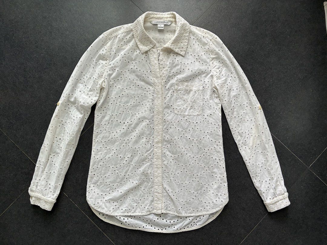 Diane von Furstenberg long-sleeved button down shirt (Category: Longsleeves) located in Batangas. Submitted by mumbee (Listing ID 1460428675, Image 2). Description: Diane von Furstenberg long-sleeved button down shirt. Cotton/silk blend fabric in cream with eyelet detail. With option to button up the sleeves halfway. With security logo for authenticity. Size 0 Fits XS-S Like new, no flaws. RFS: Too many shirts.