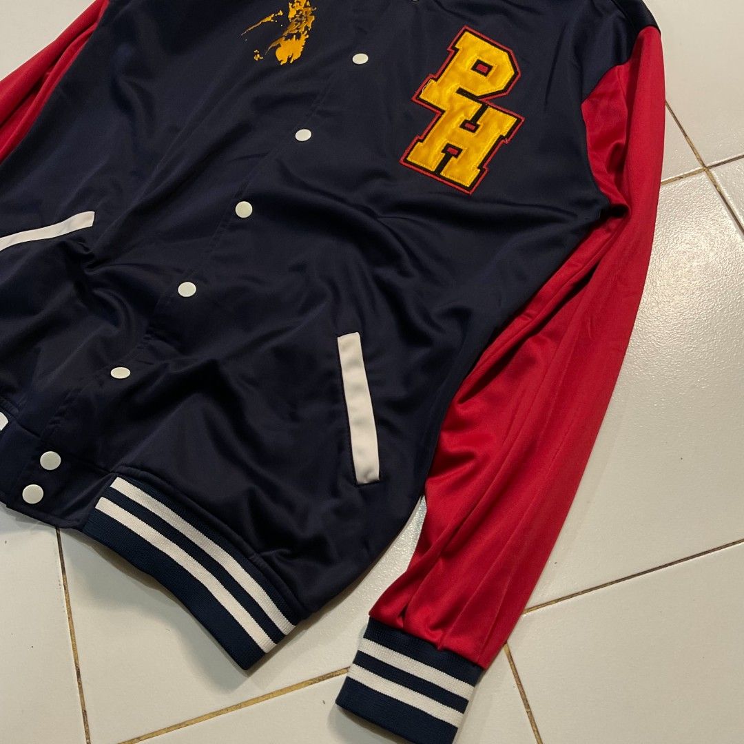 Dibuno Sportswear PH Varsity Jacket Philippines Map Design (Category: Coats, Jackets and Outerwear) located in Morong. Submitted by rusty.vault (Listing ID 1460416114, Image 3). Description: - Classic navy blue and red varsity jacket - Features a prominent 'PH' logo on the front - Showcases a unique Philippines map graphic - Comfortable ribbed cuffs and collar - Easy snap button closure - Two convenient side pockets with stylish white trim - Idea
