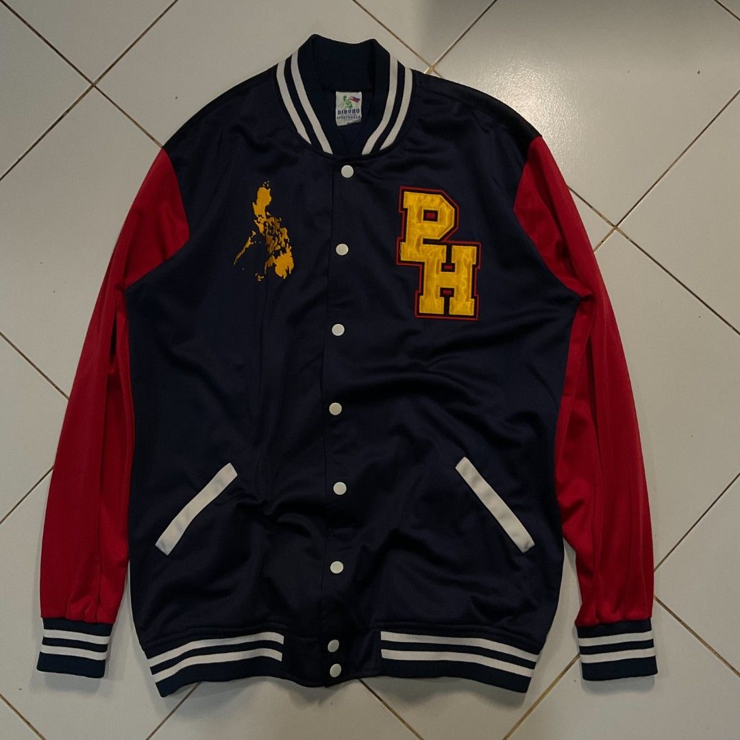 Dibuno Sportswear PH Varsity Jacket Philippines Map Design (Category: Coats, Jackets and Outerwear) located in Morong. Submitted by rusty.vault (Listing ID 1460416114, Image 1). Description: - Classic navy blue and red varsity jacket - Features a prominent 'PH' logo on the front - Showcases a unique Philippines map graphic - Comfortable ribbed cuffs and collar - Easy snap button closure - Two convenient side pockets with stylish white trim - Idea
