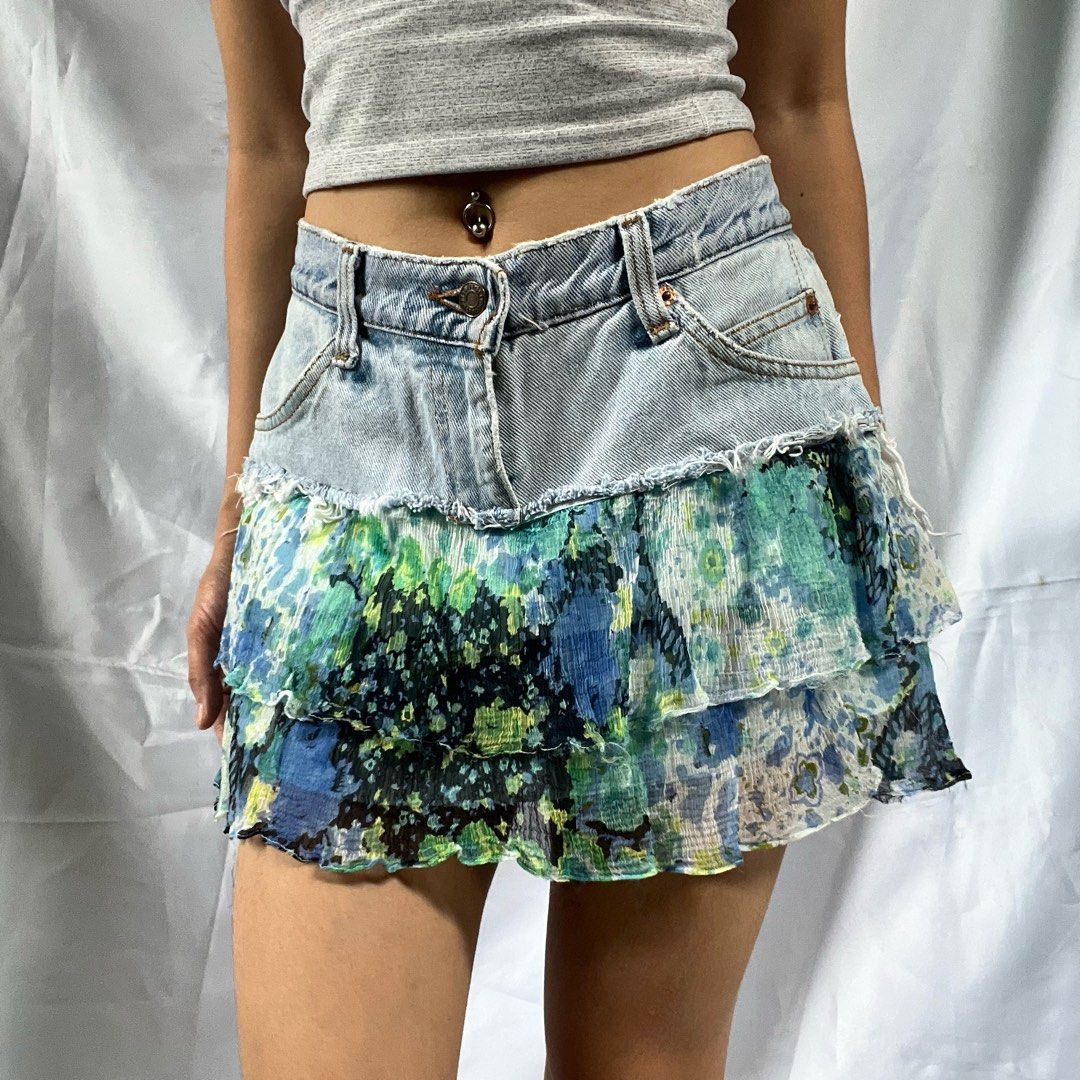 Distressed Denim Ruffle Mini Skirt Blue Floral (Category: Skirts) located in Manila. Submitted by demi.rewears (Listing ID 1460314367, Image 3). Description: Cute distressed denim mini skirt with a tiered floral ruffle hem. Features raw hem, button/zip closure, and front pockets. Perfect for casual or festival wear. Waist (Flat): 14 inches (28” circumference) Length: 12.5 inches (Micro/Mini skirt length).