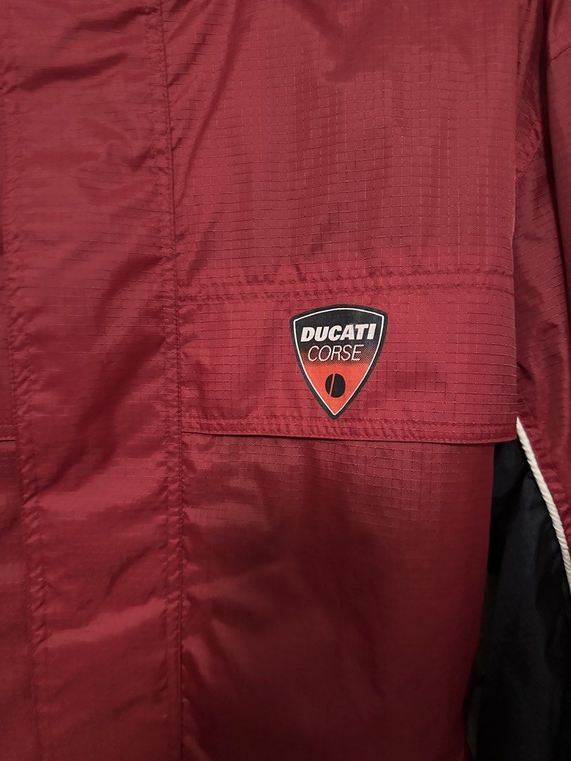Ducati Corse windbreaker jacket (Category: Coats, Jackets and Outerwear) located in Quezon City. Submitted by mancave_stuff (Listing ID 1460427032, Image 3). Description: -Ducati Corse team windbreaker jacket -SIZE: XL W24” x L31” -Lightweight & with breathable mesh lining -Ducati Red & Black racing team color -Adjustable Hoodie -Rainproof .