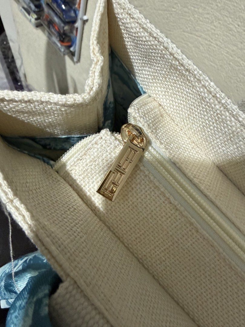 EFFY Canvas Tote Bag with Animal Print Lining (Category: Tote Bags) located in Paranaque City. Submitted by christinashoppe (Listing ID 1460434103, Image 3). Description: - Cream canvas tote bag with EFFY logo - Interior features cool blue animal print lining - Includes a zippered pocket inside - Comes with a decorative scarf tied to the handle - Ideal for everyday errands or travel.