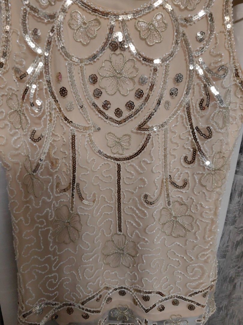 Fairy Top Sequin Mesh (Category: Sleeveless) located in Taguig. Submitted by chielatte (Listing ID 1460366197, Image 3). Description: B42xL26 00132 nude sleeveless tank top adorned with intricate silver sequins, beaded floral patterns, and a sheer scalloped hem..