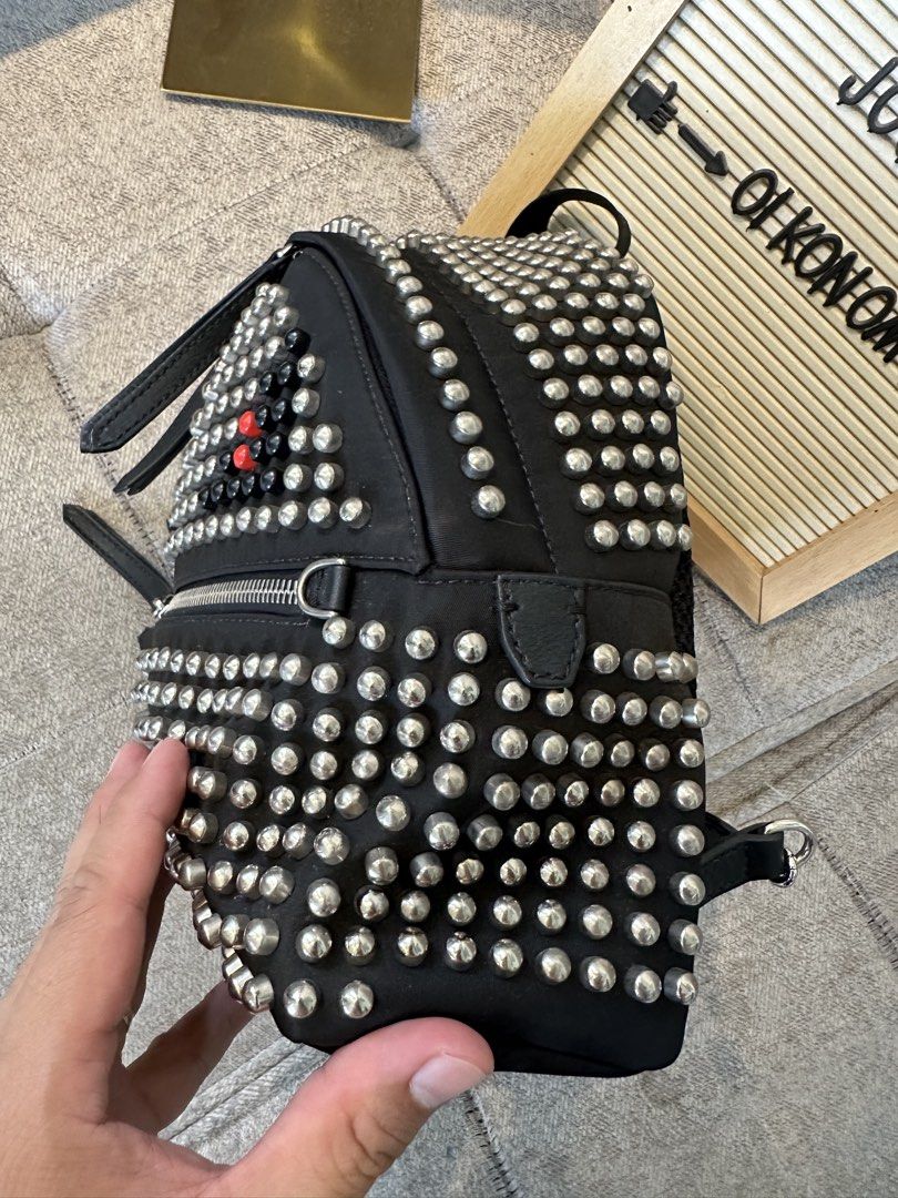 Fendi Black Studded Backpack with Red Eye Detail (Category: Backpacks) located in Los Banos. Submitted by joshua_morales (Listing ID 1460471960, Image 3). Description: -Rare Fendi Backpack - Cool black backpack with striking silver stud detailing. - Unique front design featuring red eyes. - Multiple zippered pockets for ample storage. - Adjustable straps for a comfortable fit. - Durable material for long-lasting use. - Perfect for everyday wear o