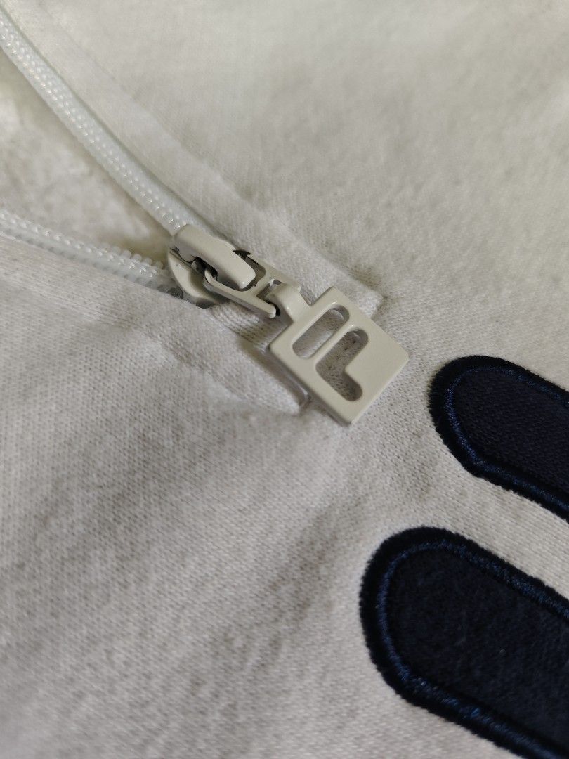 Fila White Quarter Zip Sweatshirt (Category: Coats, Jackets and Outerwear) located in Tanay. Submitted by grkfellasthriftcollection (Listing ID 1460319891, Image 3). Description: width 21 length 25 sleeve 25.5 Good Condition Size Small on tag Issue: super light yellow stain, see pictures, kayo na bahala magtanggal.