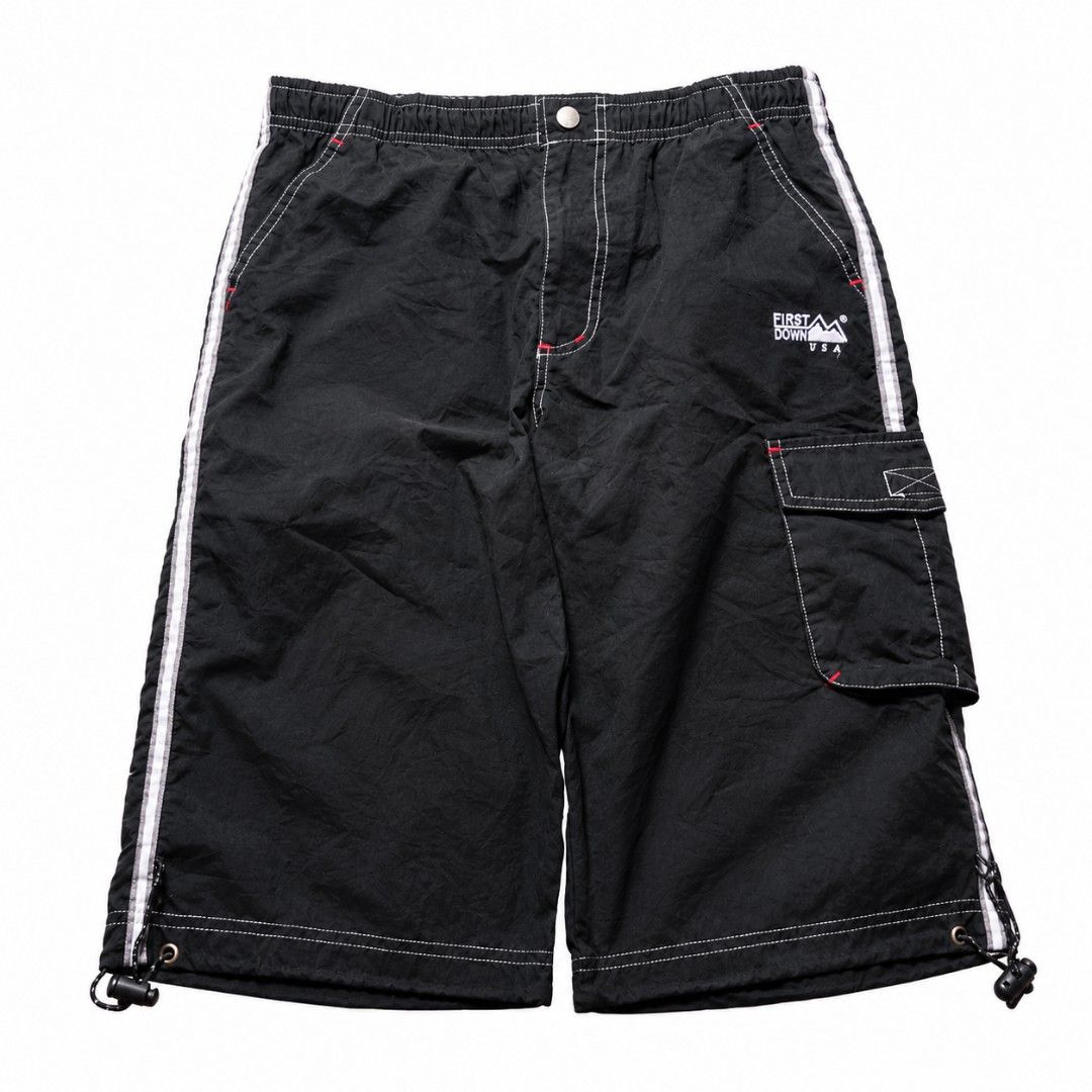 FIRST DOWN USA Black Cargo Shorts with White Stripes (Category: Shorts) located in Manila. Submitted by chieezz (Listing ID 1460316464, Image 1). Description: - Brand: FIRST DOWN USA - Color: Black - Features: White stripes down the sides, contrast stitching - Waist: Elastic waistband with button closure - Pockets: Cargo pocket on the right leg - Details: Drawstring at the hem - Style: Great for casual wear.