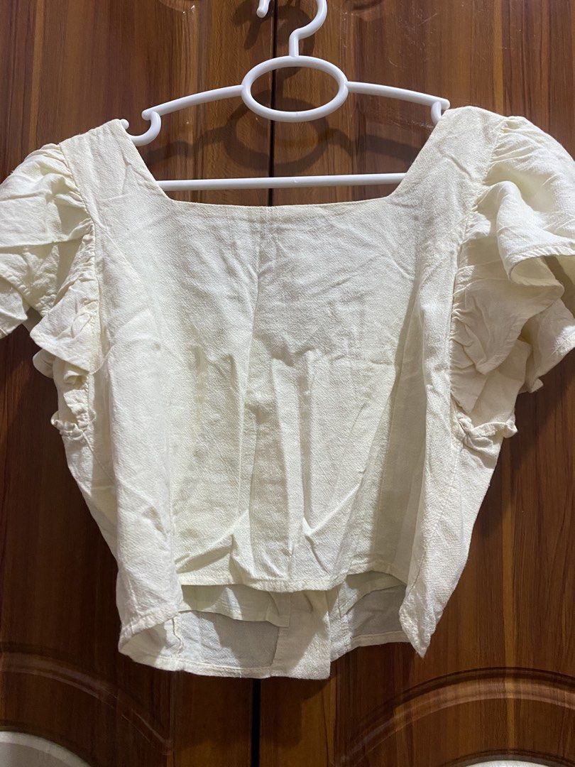 Forme Cream Square Neck Button Up Puff Sleeve Top (Category: Blouses) located in Dagupan City. Submitted by prelovedbybel_026 (Listing ID 1460430754, Image 3). Description: - Cream colored top from Forme - Features a square neckline and button-up front - Puff sleeves with ruffled details - Made in the Philippines - Versatile for casual or dressed-up looks.