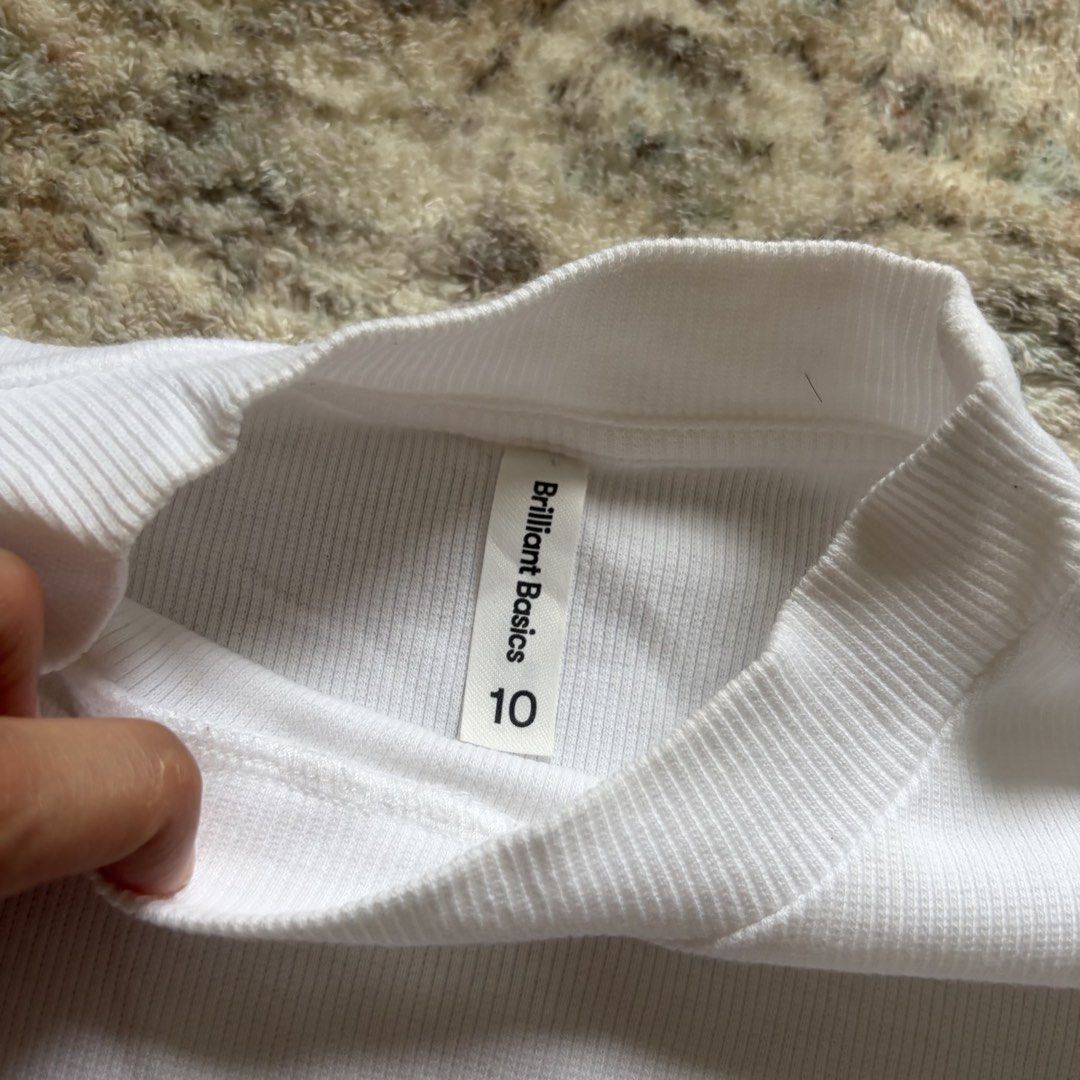 FREE FOR BUYER (Category: Shirts) located in Pasig City. Submitted by mariannesnts (Listing ID 1460506517, Image 2). Description: - Brilliant Basics white ribbed t-shirt - Mock neck style - Short sleeves - Size 10 - Simple, classic, and versatile - Perfect for layering or wearing on its own - Ribbed texture for added detail.