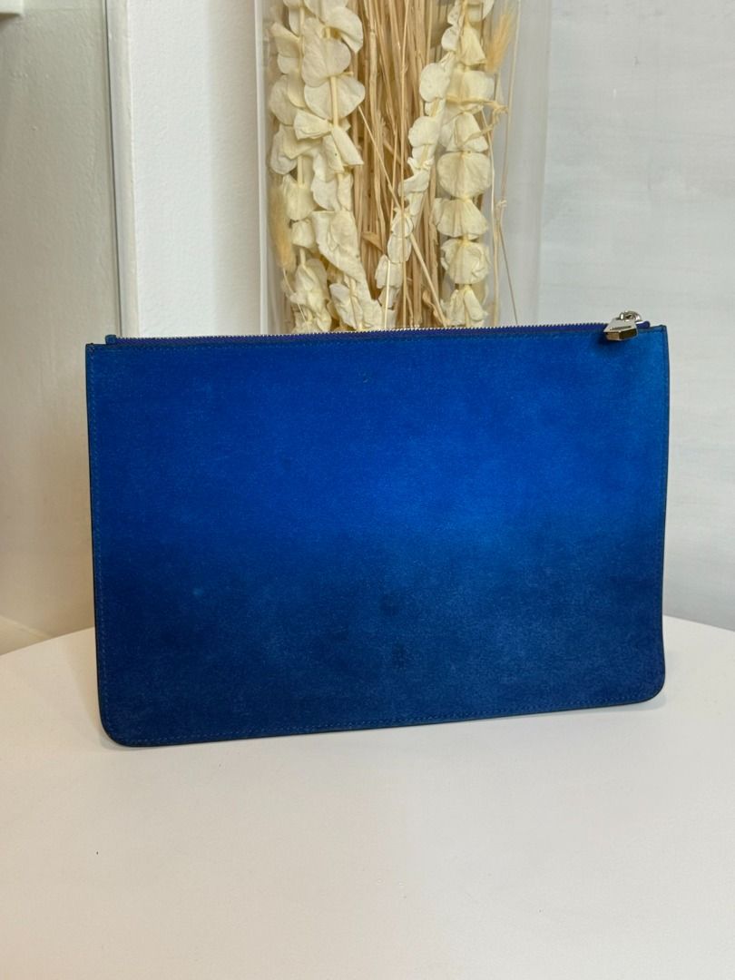 Givenchy Paris Blue Gradient Pouch (Category: Purses & Pouches) located in Las Pinas. Submitted by happystar_cac724 (Listing ID 1460405796, Image 2). Description: - Authentic Givenchy pouch - Iconic blue gradient Givenchy Paris logo - Silver interior lining - Perfect for organizing essentials or as a clutch - Smooth zipper closure - Shows some signs of exterior wear consistent with use Givenchy pouch In used condition Pouch only no other inclusio