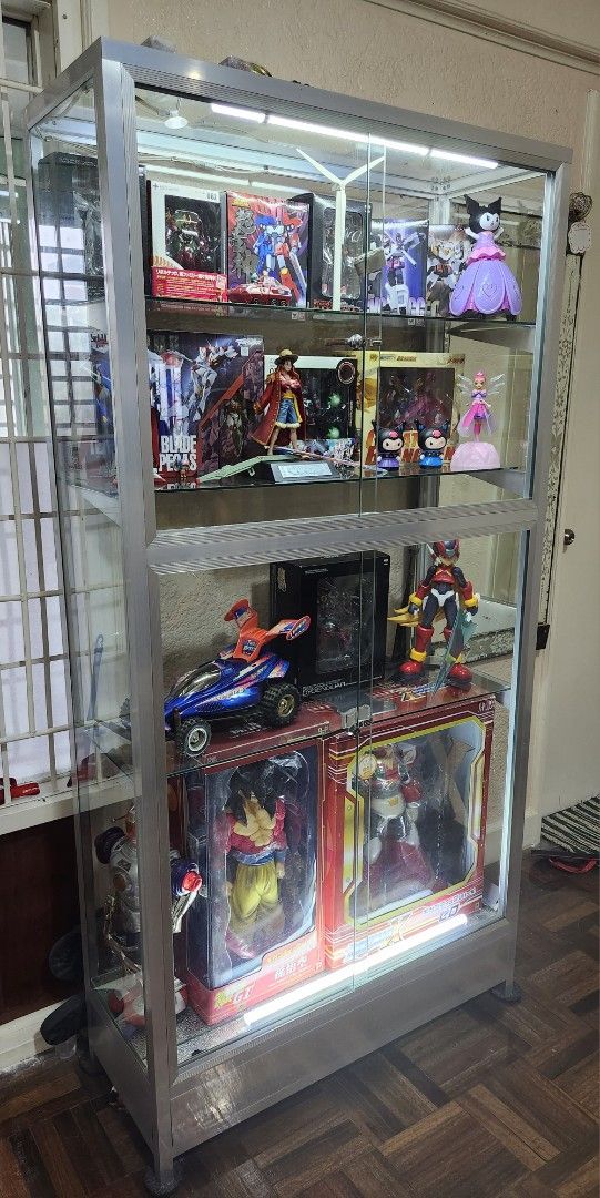 Glass Display Cabinet with LED Lights (Category: Shelves, Cabinets & Racks) located in Cavite. Submitted by rjcad777 (Listing ID 1460326120, Image 3). Description: - 6ft tall display cabinet - 3ft wide - 14 inches deep - 4 tier glass shelf - Includes LED lighting - Made of metal and glass - Ideal for displaying collectibles - 2 key locks with working keys. - the front picture is the ideal back part of the glass display. The back must be the front