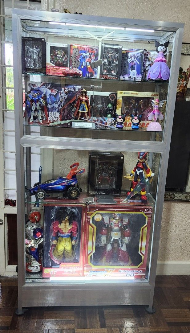 Glass Display Cabinet with LED Lights (Category: Shelves, Cabinets & Racks) located in Cavite. Submitted by rjcad777 (Listing ID 1460326120, Image 1). Description: - 6ft tall display cabinet - 3ft wide - 14 inches deep - 4 tier glass shelf - Includes LED lighting - Made of metal and glass - Ideal for displaying collectibles - 2 key locks with working keys. - the front picture is the ideal back part of the glass display. The back must be the front
