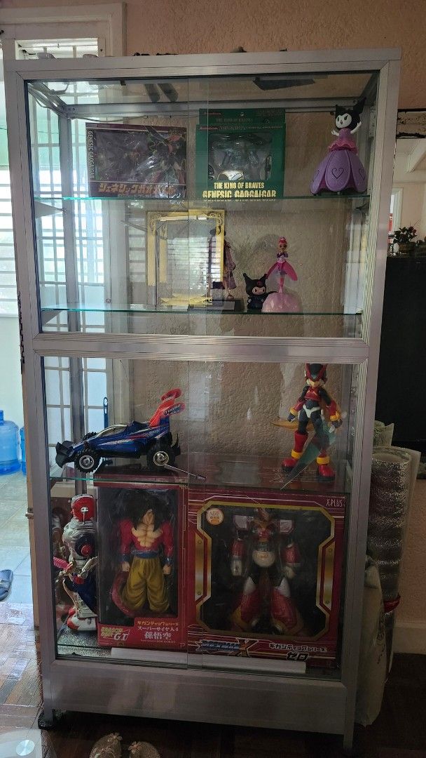 Glass Display Cabinet with LED Lights (Category: Shelves, Cabinets & Racks) located in Cavite. Submitted by rjcad777 (Listing ID 1460326120, Image 2). Description: - 6ft tall display cabinet - 3ft wide - 14 inches deep - 4 tier glass shelf - Includes LED lighting - Made of metal and glass - Ideal for displaying collectibles - 2 key locks with working keys. - the front picture is the ideal back part of the glass display. The back must be the front