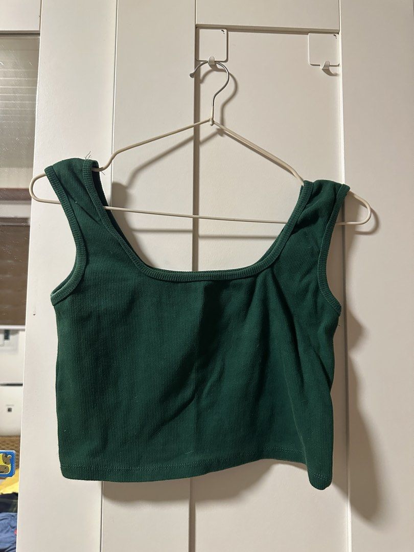 Green Ribbed Square Neck Tank Top (Category: Sleeveless) located in Malolos. Submitted by fituccine (Listing ID 1460417459, Image 1). Description: - Dark green ribbed tank top - Square neckline with thick straps - Cropped length - Stretchy material for a comfortable fit - Perfect for layering or wearing on its own - Easily pairs with jeans or skirts.