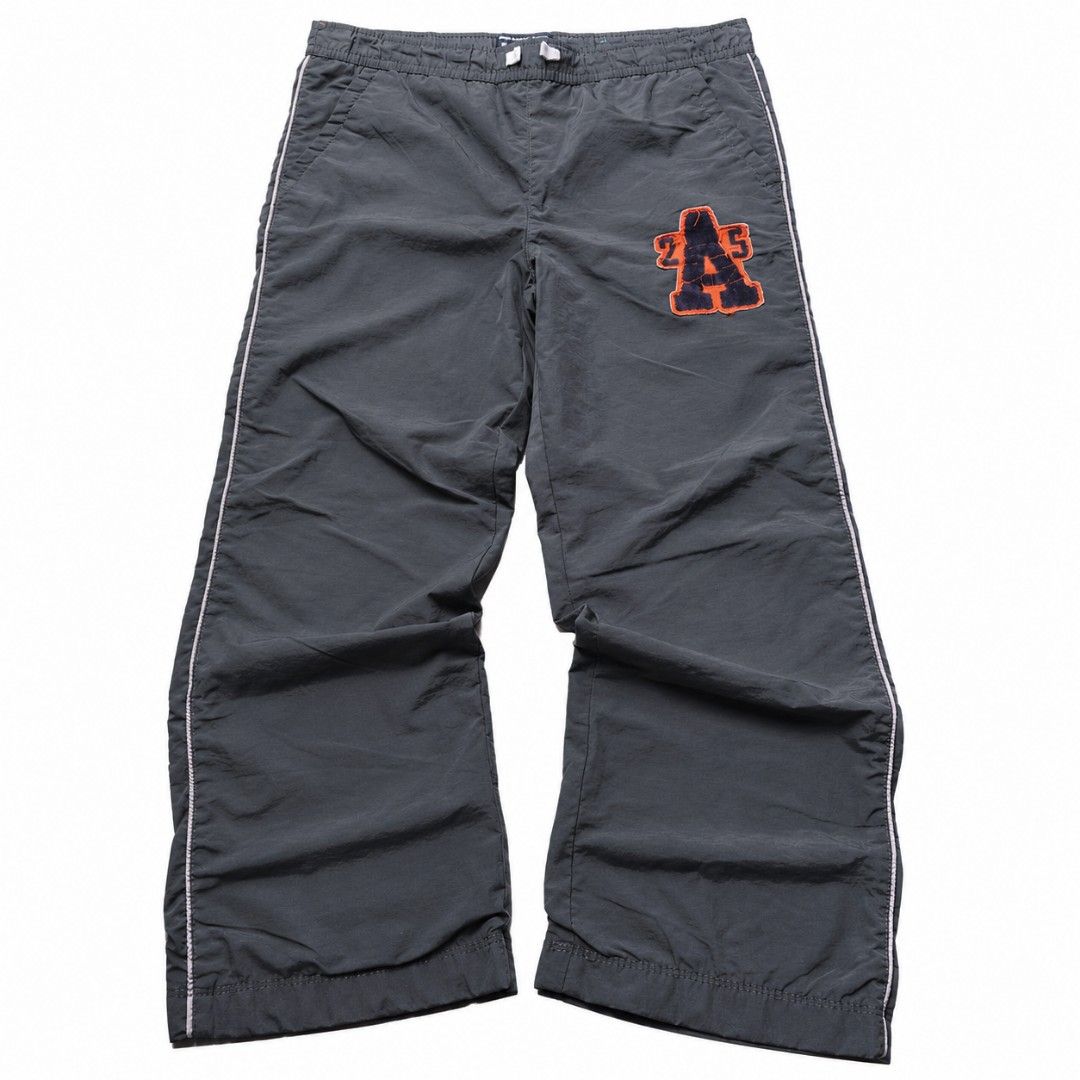 Grey Track Pants with 'A' Patch and Side Stripe (Category: Other Bottoms) located in Manila. Submitted by chieezz (Listing ID 1460316659, Image 1). Description: - Grey track pants - Orange and navy 'A' patch on right leg - White stripe down each side - Elastic waistband with drawstring - Ideal for casual wear or sports.