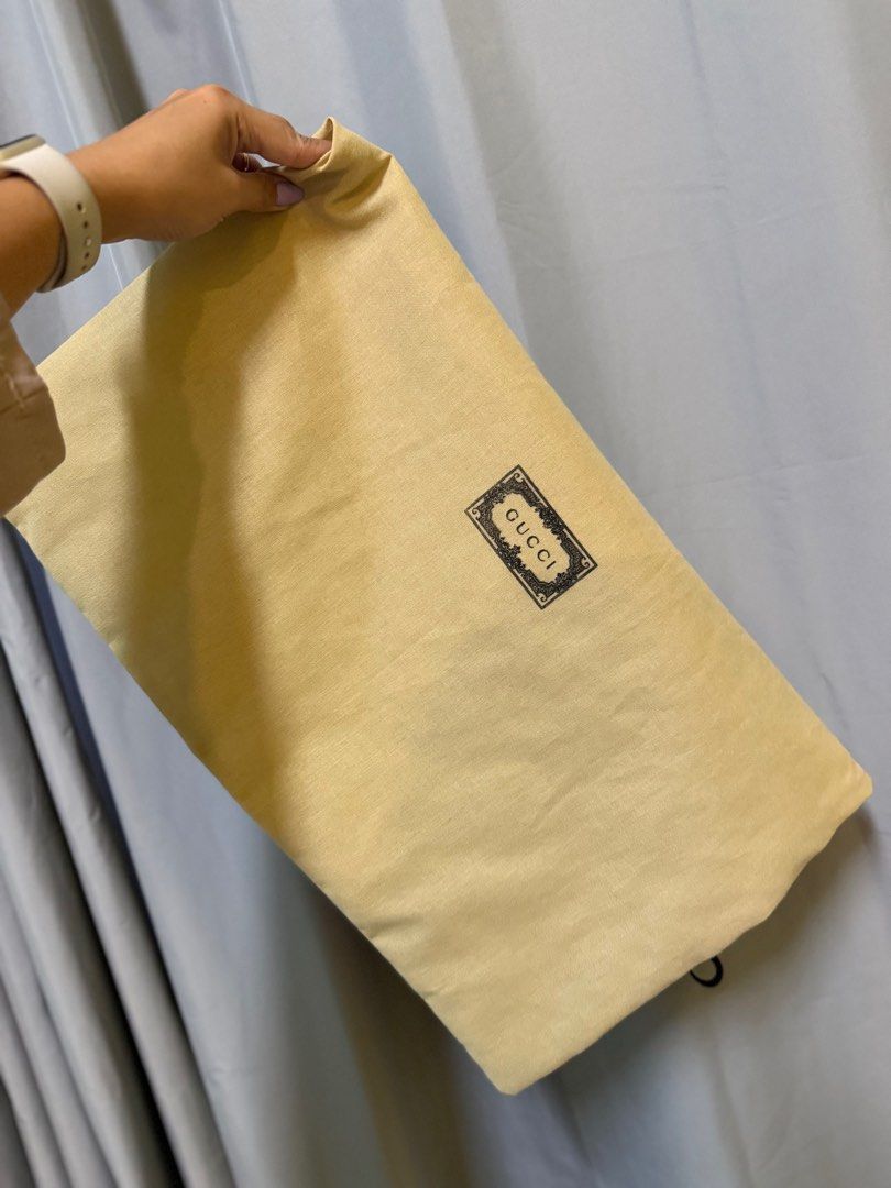 Gucci Dust Bag (Category: Luxury Bags & Wallets) located in Manila. Submitted by previosly.mine (Listing ID 1460420484, Image 1). Description: - Authentic Gucci dust bag - Color: Beige - Dimensions: Approx. 48 cm x 40 cm (large) - Features Gucci logo print - Ideal for storing bags or shoes - Secure drawstring closure.