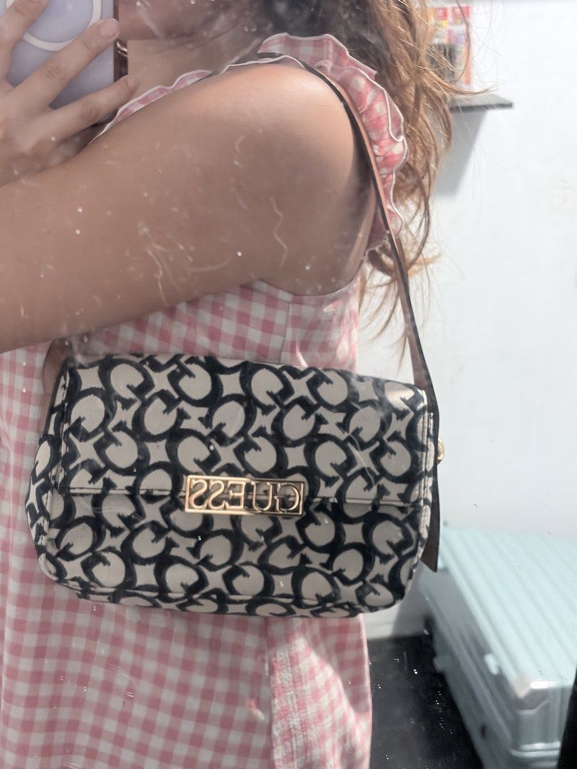 Guess Monogram Shoulder Bag with Dust Bag (Category: Luxury Bags & Wallets) located in Quezon City. Submitted by liacleofas (Listing ID 1460456625, Image 3). Description: - Cute Guess shoulder bag - All-over black and white monogram print - Gold hardware with Guess logo on front - Includes original Guess dust bag - Perfect size for essentials - Great for casual outings.