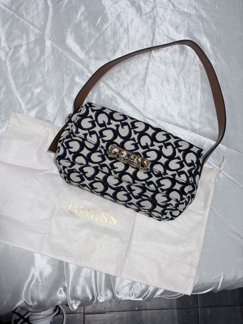Guess Monogram Shoulder Bag with Dust Bag (Category: Luxury Bags & Wallets) located in Quezon City. Submitted by liacleofas (Listing ID 1460456625, Image 1). Description: - Cute Guess shoulder bag - All-over black and white monogram print - Gold hardware with Guess logo on front - Includes original Guess dust bag - Perfect size for essentials - Great for casual outings.