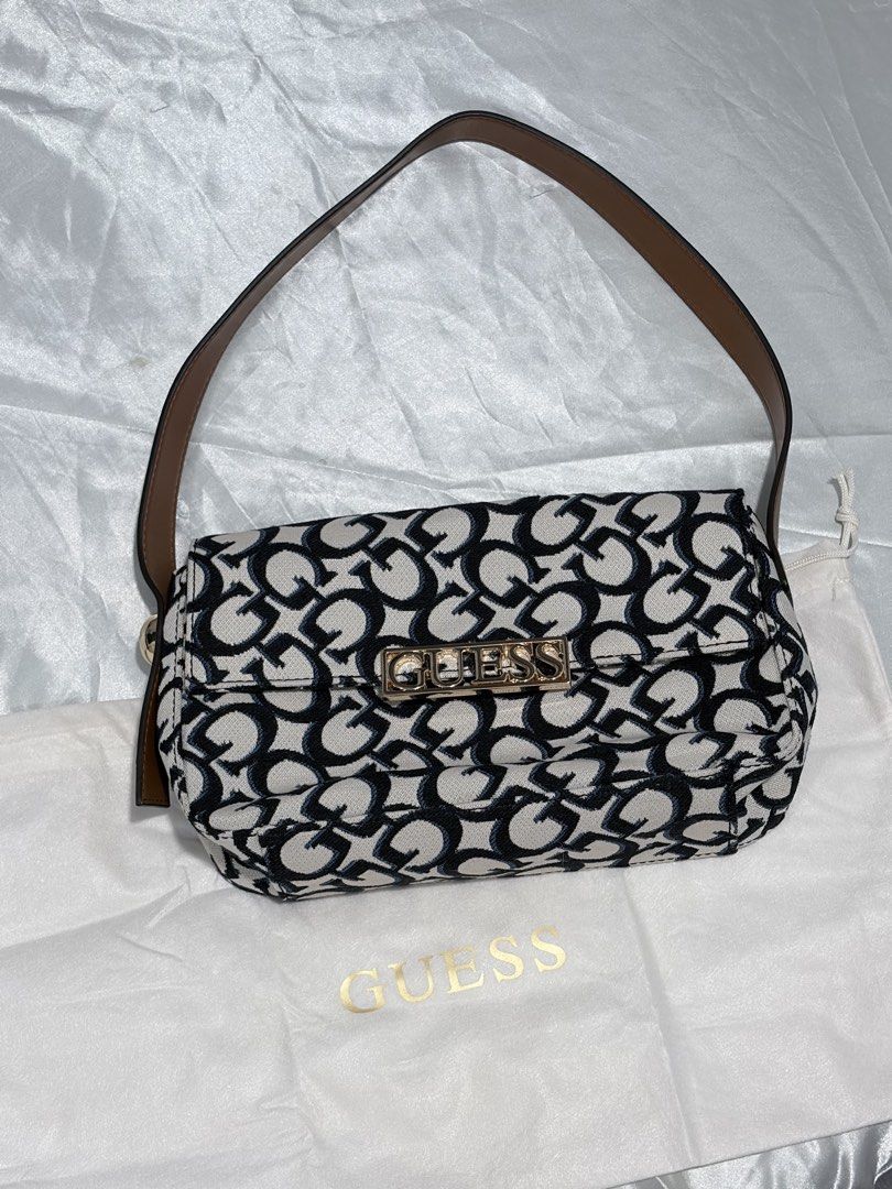 Guess Monogram Shoulder Bag with Dust Bag (Category: Luxury Bags & Wallets) located in Quezon City. Submitted by liacleofas (Listing ID 1460456625, Image 2). Description: - Cute Guess shoulder bag - All-over black and white monogram print - Gold hardware with Guess logo on front - Includes original Guess dust bag - Perfect size for essentials - Great for casual outings.
