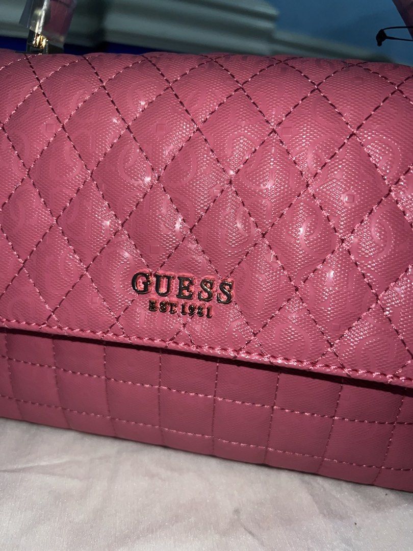 Guess Quilted Pink Handbag with Strap (Category: Luxury Bags & Wallets) located in Quezon City. Submitted by velmarae (Listing ID 1460374833, Image 2). Description: - Brand new pink Guess handbag with sling - with dust bag (has some stain BUT bag itself is in mint condition) - comes with guess tote bag - Versatile with top handle and detachable shoulder strap - Convenient back zipper pocket - Interior features Guess branded lining - Never used, p