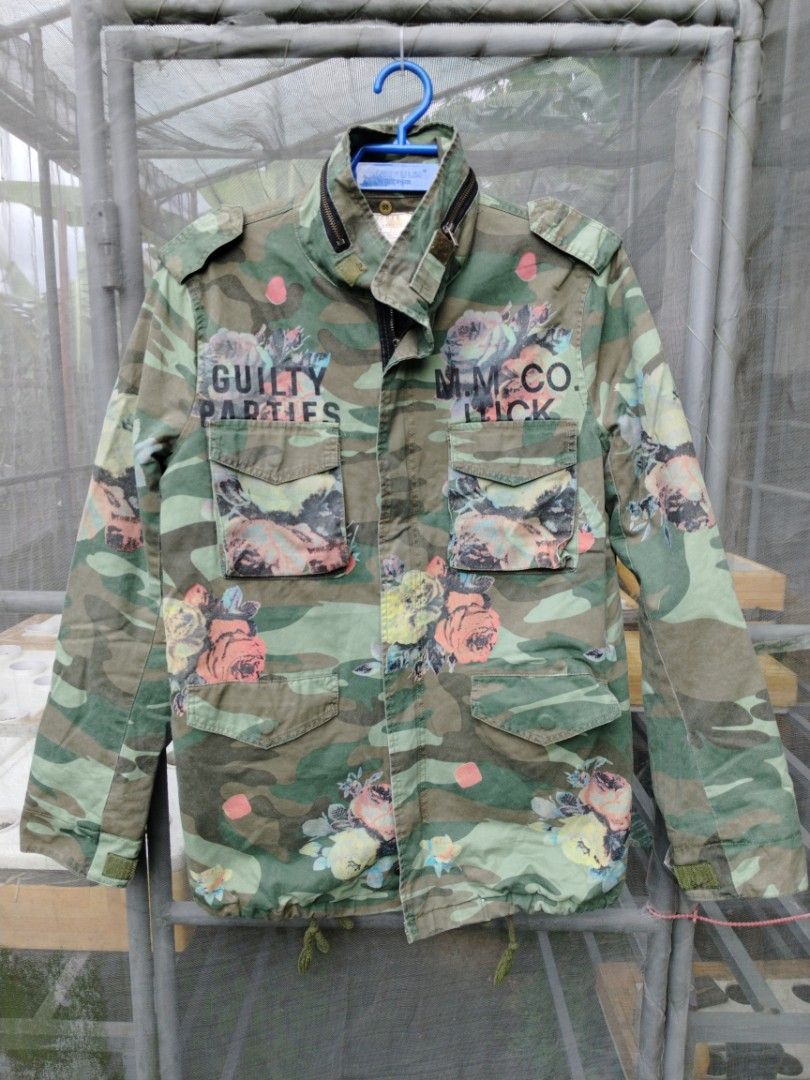 Guilty Parties Camo Floral Jacket (Category: Coats, Jackets and Outerwear) located in Legazpi City. Submitted by genobecollectives (Listing ID 1460437537, Image 1). Description: - Unique camo jacket with a stylish floral print. - Features 'Guilty Parties' and 'M.M. Co. Luck' graphic details. - Multiple functional pockets on the front. - Secure zip and button closure. - Made by Skyeye, a brand established in 1993. 800 add sf 22 x 30 .