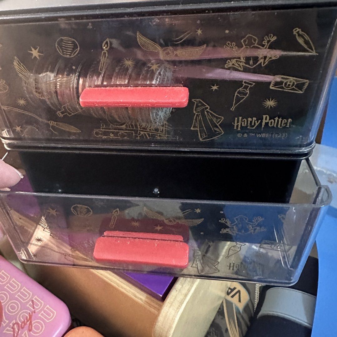 Harry Potter Storage Boxes with Drawers (Category: Storage Boxes & Baskets) located in Kawit. Submitted by wevibevintage (Listing ID 1460327117, Image 2). Description: - Two stackable Harry Potter storage boxes. - Black with gold line art of iconic Harry Potter symbols (Golden Snitch, Hogwarts Express, etc.). - Each box features a red pull handle for easy access. - Ideal for organizing small items, desk supplies, or collectibles. - A must-have fo