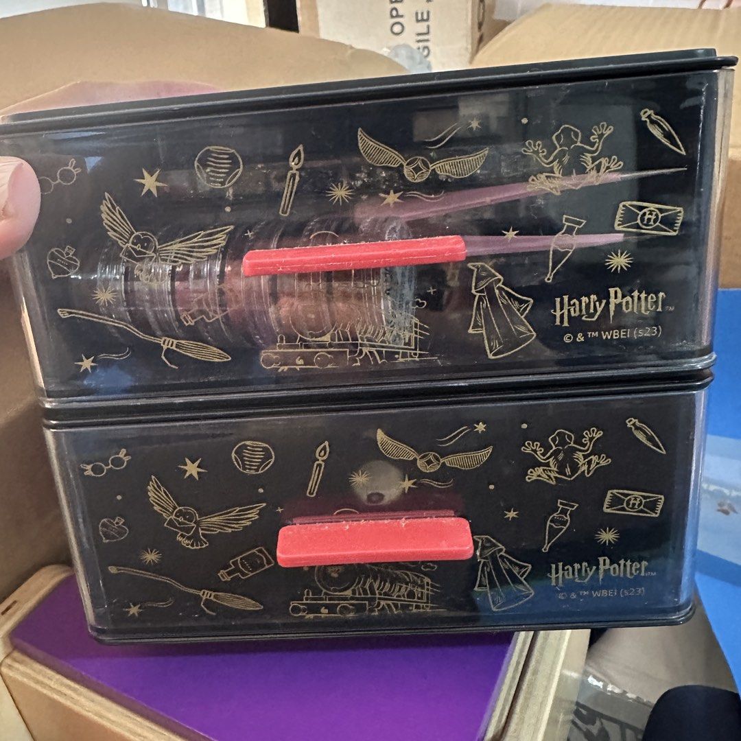 Harry Potter Storage Boxes with Drawers (Category: Storage Boxes & Baskets) located in Kawit. Submitted by wevibevintage (Listing ID 1460327117, Image 1). Description: - Two stackable Harry Potter storage boxes. - Black with gold line art of iconic Harry Potter symbols (Golden Snitch, Hogwarts Express, etc.). - Each box features a red pull handle for easy access. - Ideal for organizing small items, desk supplies, or collectibles. - A must-have fo