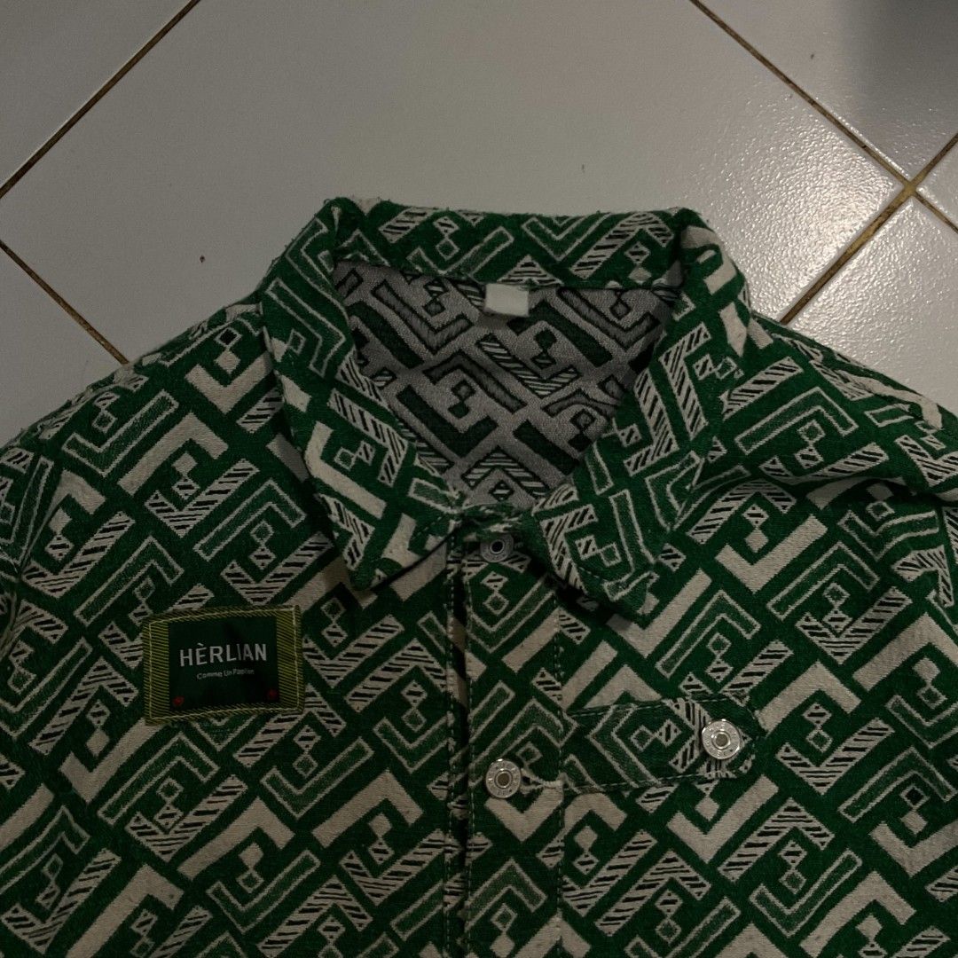HERLIAN Green Geometric Pattern Button-Up Jacket (Category: Coats, Jackets and Outerwear) located in Morong. Submitted by rusty.vault (Listing ID 1460457167, Image 2). Description: - Stylish cool green jacket - Unique geometric pattern - HERLIAN brand patch on chest - Button-up front closure - Two chest pockets - Ideal for casual wear.