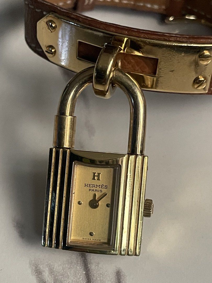 Hermes Paris "Kelly" Lock Watch (Category: Women's Watches) located in Taguig. Submitted by j_watches007 (Listing ID 1460318397, Image 2). Description: Authentic Secondhand ⌚ Hermes Paris Watch Swiss Made Quartz Serial Number: 796857 Plaque: 6 10 M Elegant Gold Tone Case with Lock Design Classic Brown Leather Strap Authentic Secondhand ⌚ “Watch Only” DISCLAIMER: IT’S OLD USED WATCHES EXPECT SOME SCRATCHES, SIGNS OF USED & PLEASE MANAGE YOUR EXPEC