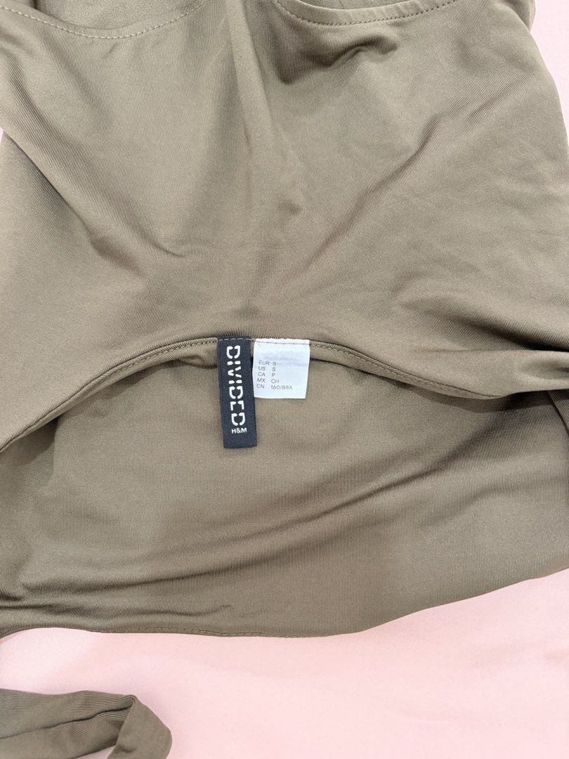 H&M DIVIDED SQUARE NECK BODYSUIT (Category: Others Tops) located in Abulug. Submitted by joysmithznjo (Listing ID 1460467668, Image 2). Description: - Olive green bodysuit from H&M Divided - Features a square neckline and thick straps - Thong bottom for a seamless look - Made with stretchy material for comfort - A versatile basic piece for any wardrobe - Can be dressed up or down.