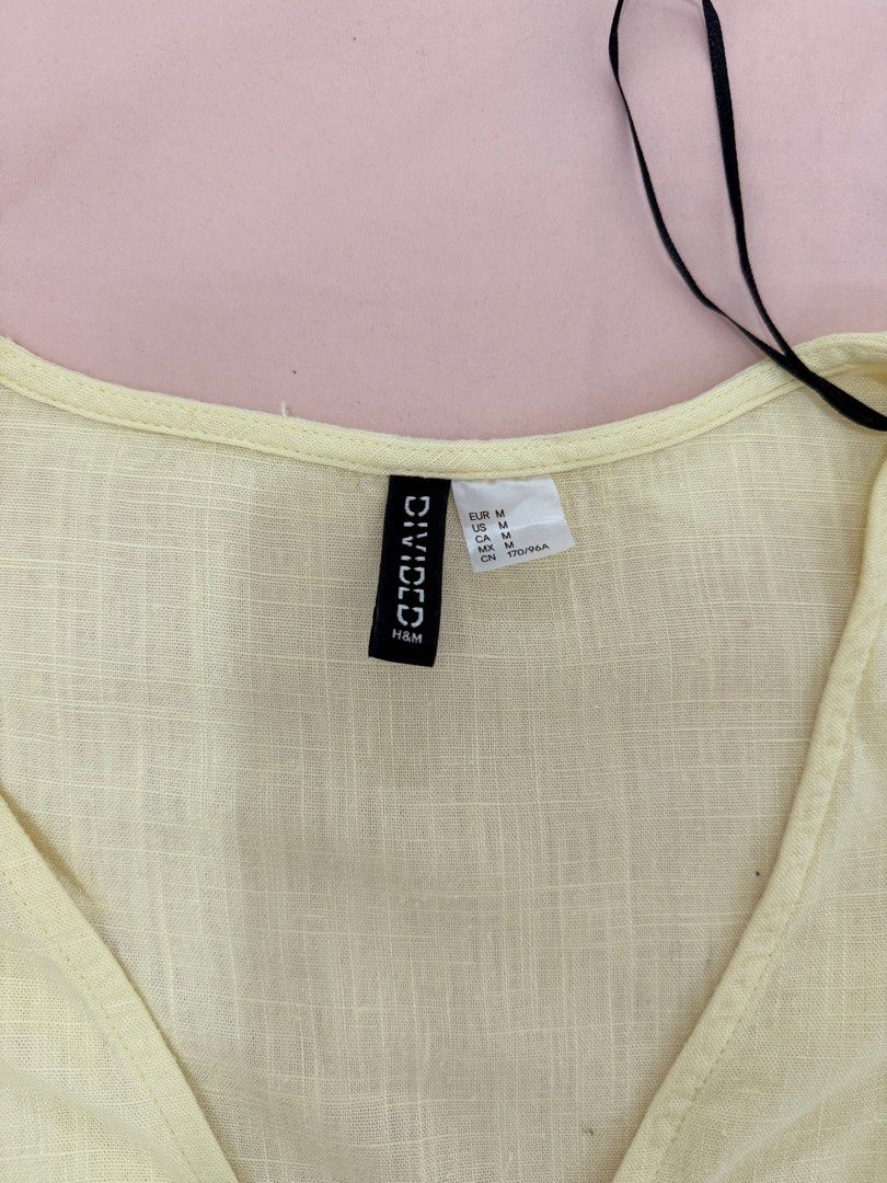 H&M DIVIDED WRAP CROP TOP (Category: Blouses) located in Abulug. Submitted by joysmithznjo (Listing ID 1460425767, Image 2). Description: - Cute yellow wrap crop top from H&M Divided - Made with a breathable linen blend fabric - Features short sleeves with charming flutter detail - Adjustable side ties for a perfect fit - Versatile for casual or dressed-up looks - Size Medium (M).