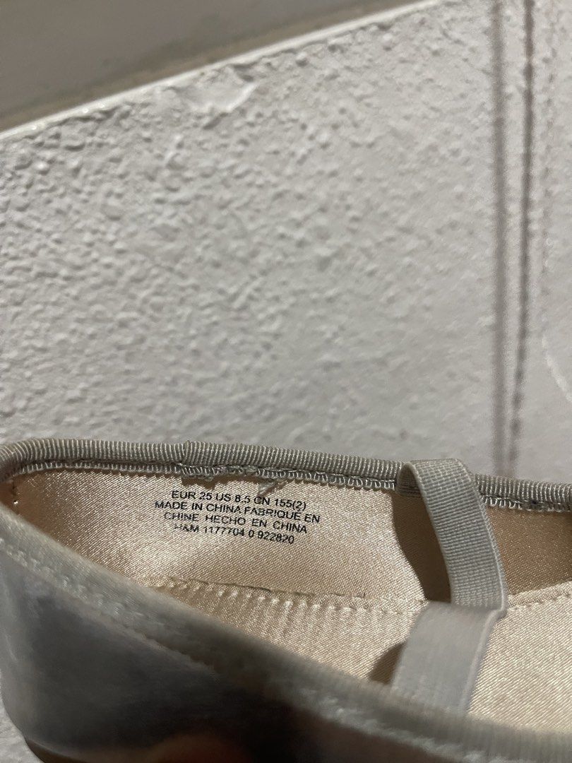 H&M Silver Ballet Flats with Elastic Strap - Size 25 (Category: Flats & Sandals) located in Manila. Submitted by brahma806 (Listing ID 1460395404, Image 3). Description: - H&M silver ballet flats - Size euro25/8.5US - Cute bow detail on the front - Comfortable elastic strap across the foot - H&M logo inside - Versatile for everyday wear or special occasions.